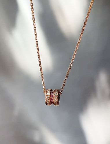 Rose gold pendant with white diamonds and pink sapphires, featuring an elegant and sophisticated design.