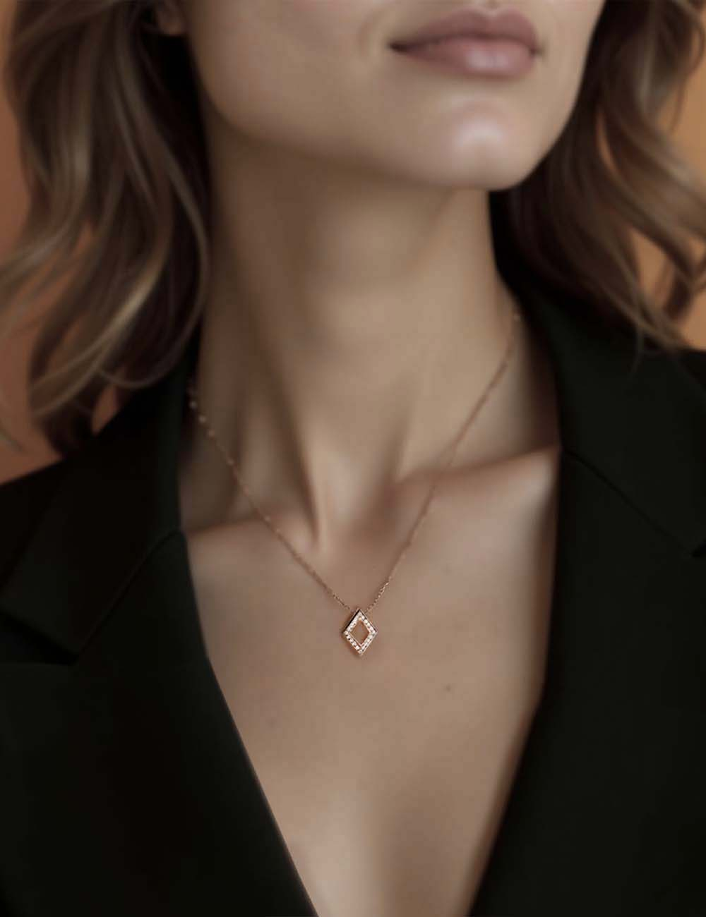 Modern and original women's pendant, diamond-shaped, crafted in gold and set with brilliant white diamonds.